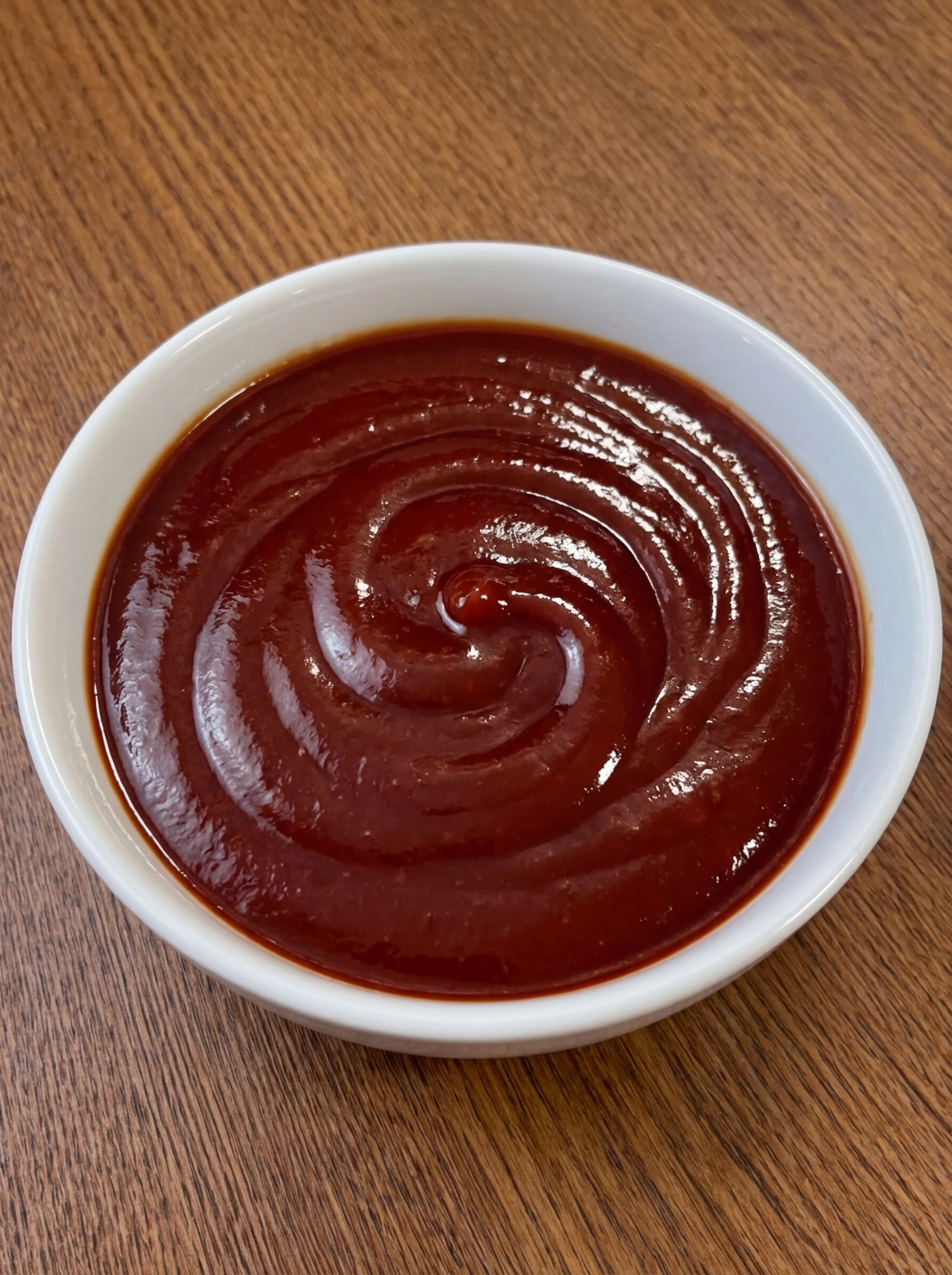 Sweet and tangy meatloaf glaze in a white ceramic bowl