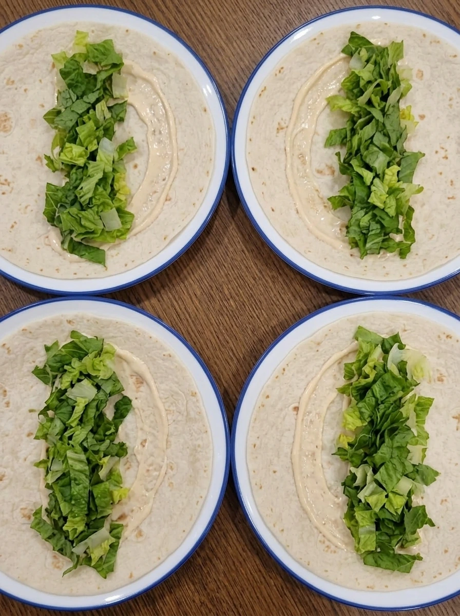 Tortillas with sauce and lettuce prepared for easy chicken wrap