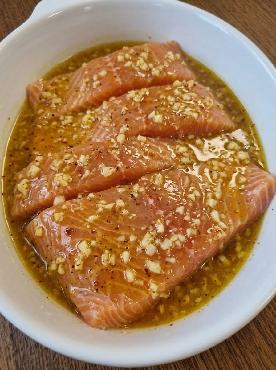 Raw salmon fillets coated with lemon garlic mixture