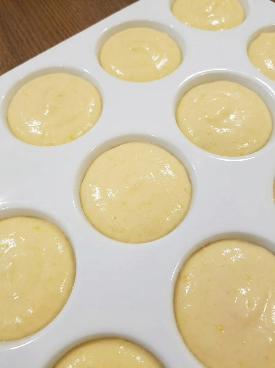 Mini cake tray filled with raw lemon cake batter