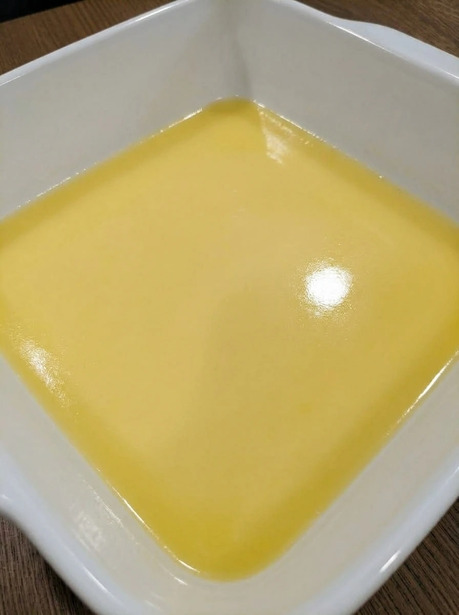 Melted butter spread in a white ceramic baking dish