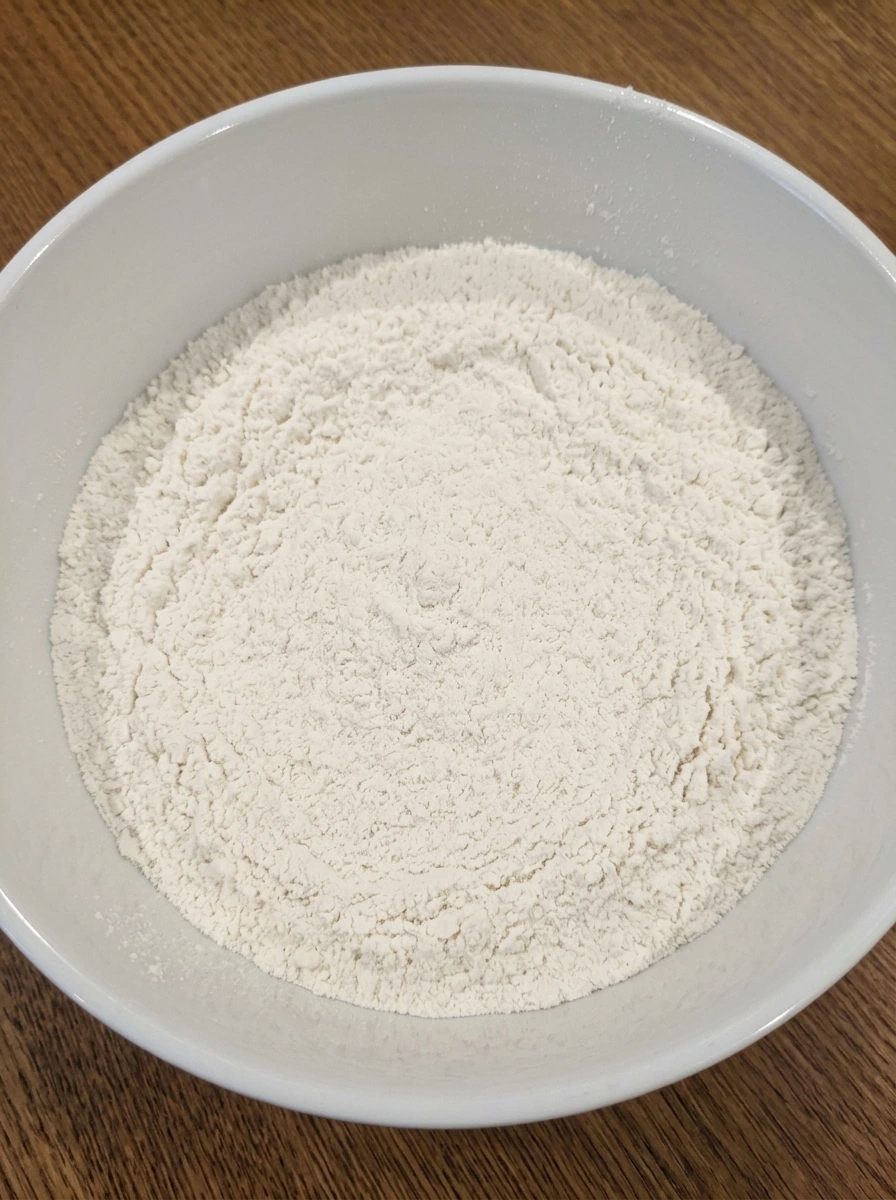 Dry ingredients whisked in a white ceramic bowl