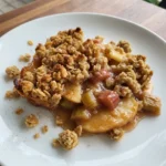 Apple Rhubarb Crumble served warm with golden topping and tender fruit.