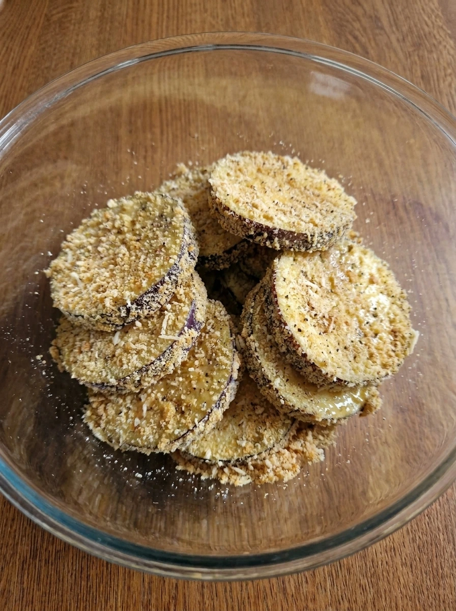 Breadcrumb coated eggplant rounds ready to bake for Baked Eggplant Parmesan.