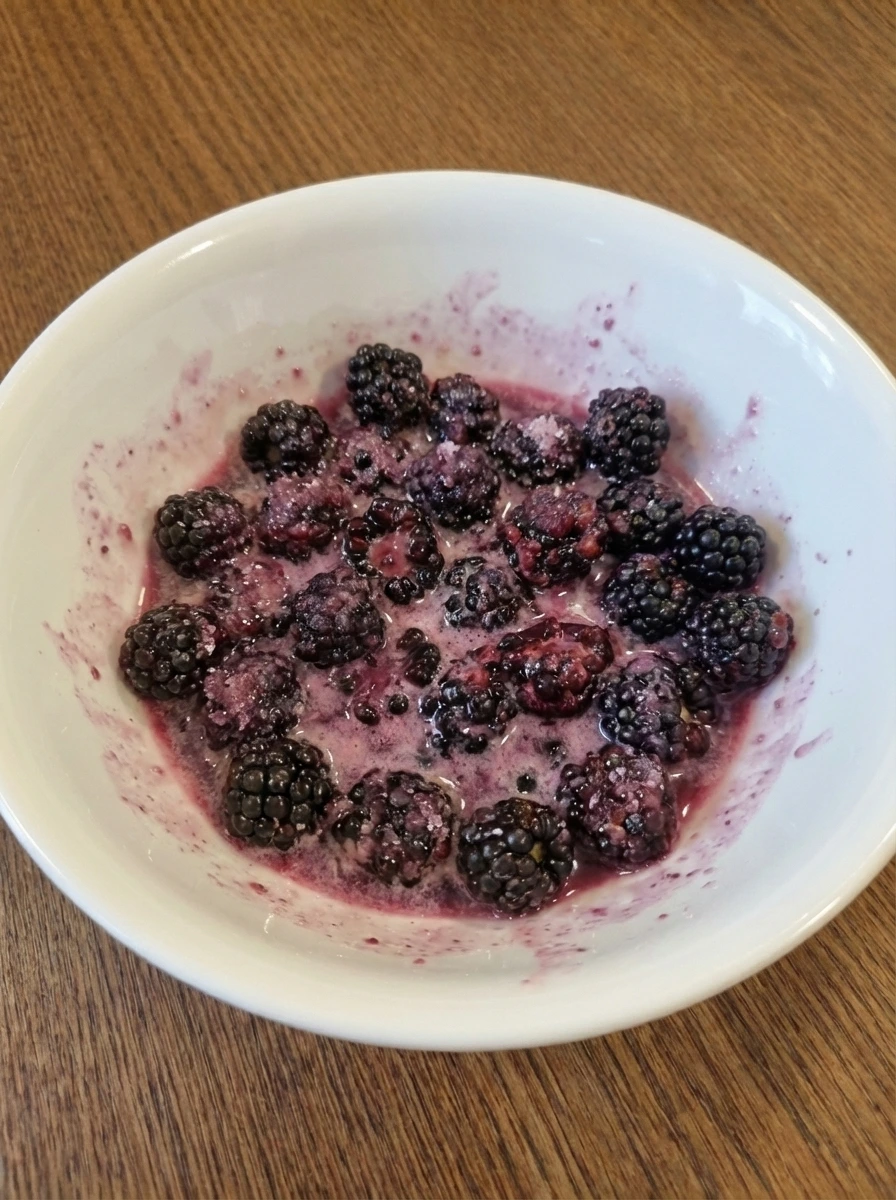 Blackberry filling mixed with cornstarch in a white dish
