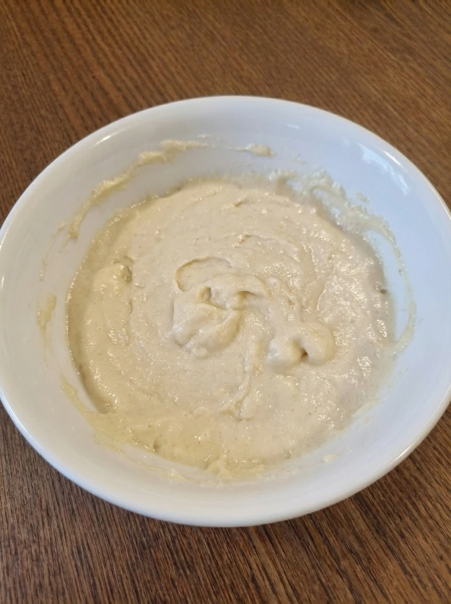 Pale cobbler batter just mixed in a white dish