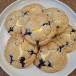 Blueberry Cheesecake Cookies on a matte white stoneware dessert plate with golden edges and creamy swirls.