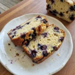 blueberry cream cheese bread sliced with golden crust and creamy swirls