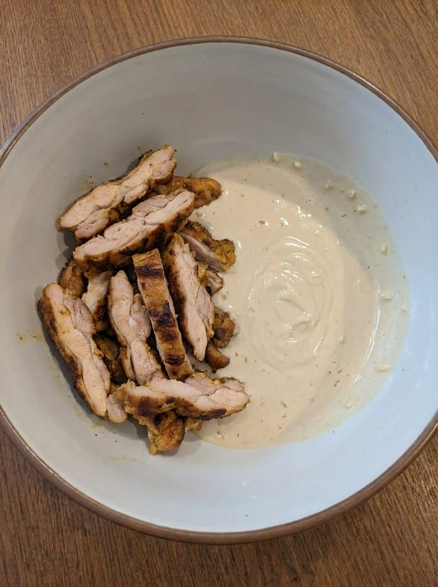 Sliced shawarma chicken with creamy garlic tahini sauce