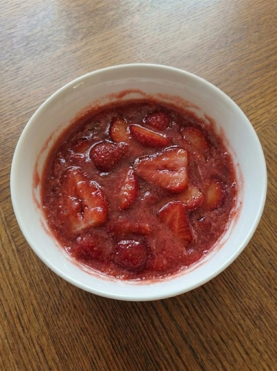 Chilled crustless strawberry pie with softly set glossy berry filling in a natural white dish