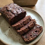 moist chocolate zucchini bread sliced with melted chocolate pockets