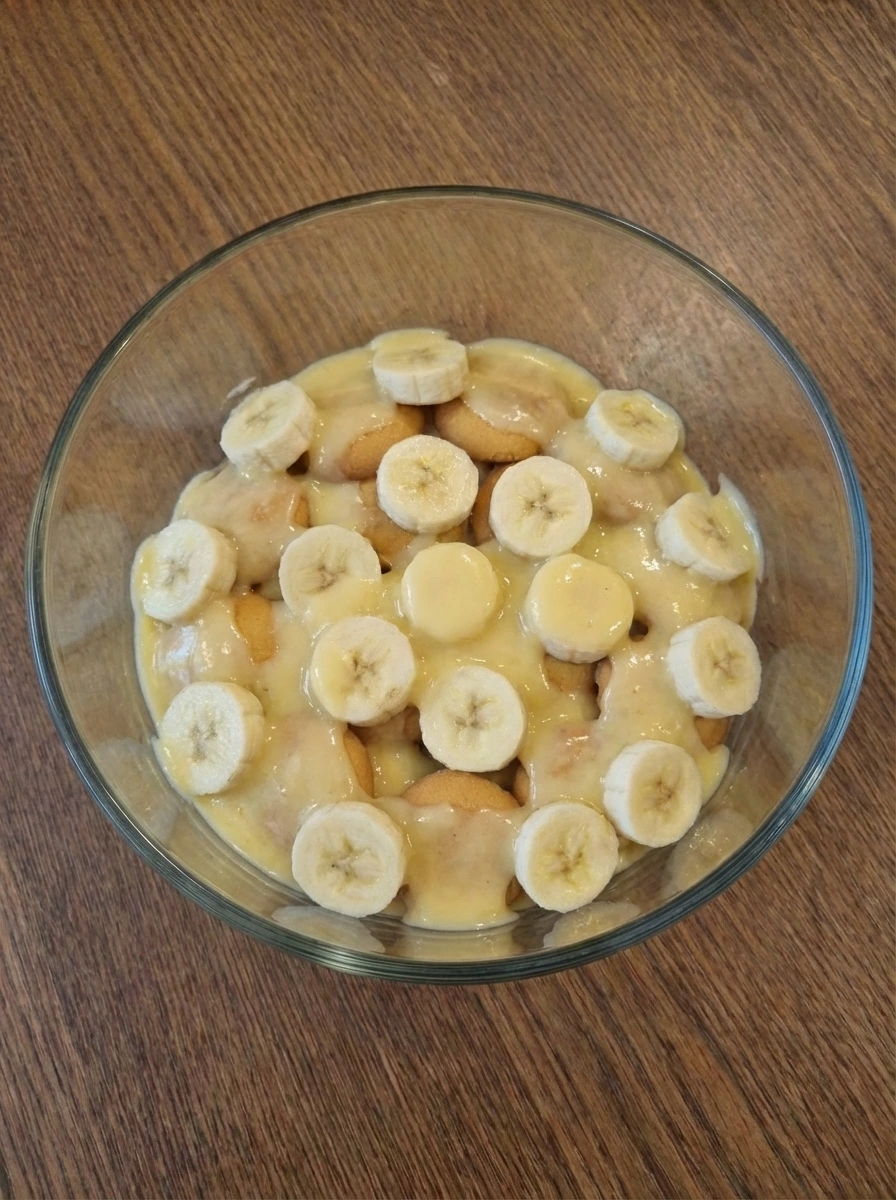 Warm custard poured over banana and wafer layer