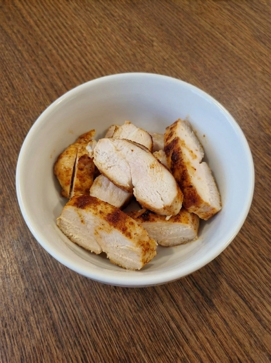 Cooked sliced chicken with light browning for Cobb Salad