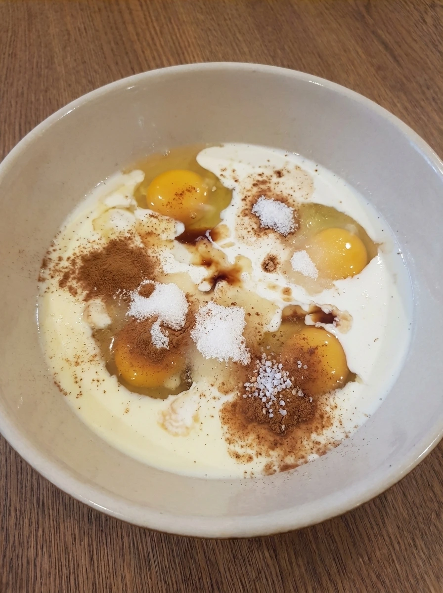 Custard ingredients measured in a bowl for Classic French Toast