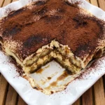 Classic Italian Tiramisu with cocoa dusting and visible creamy layers.