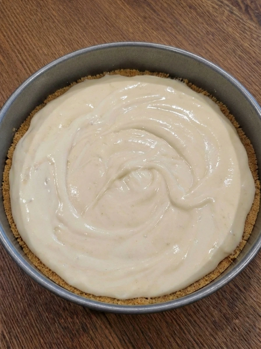 Cheesecake batter poured over crust in a springform pan