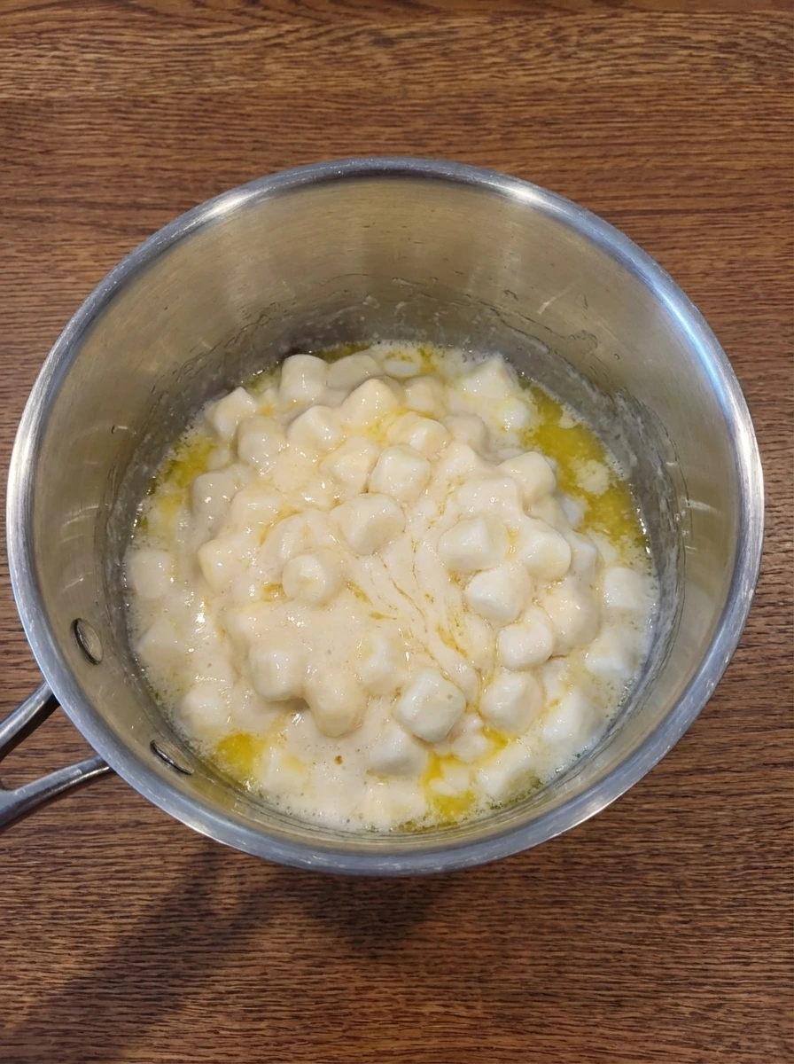 Butter and marshmallows melting into a glossy mixture for Classic Rice Krispie Treats