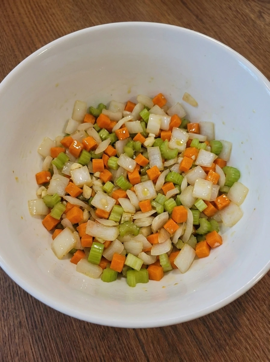 Diced onion carrot and celery lightly coated in oil and beginning to soften