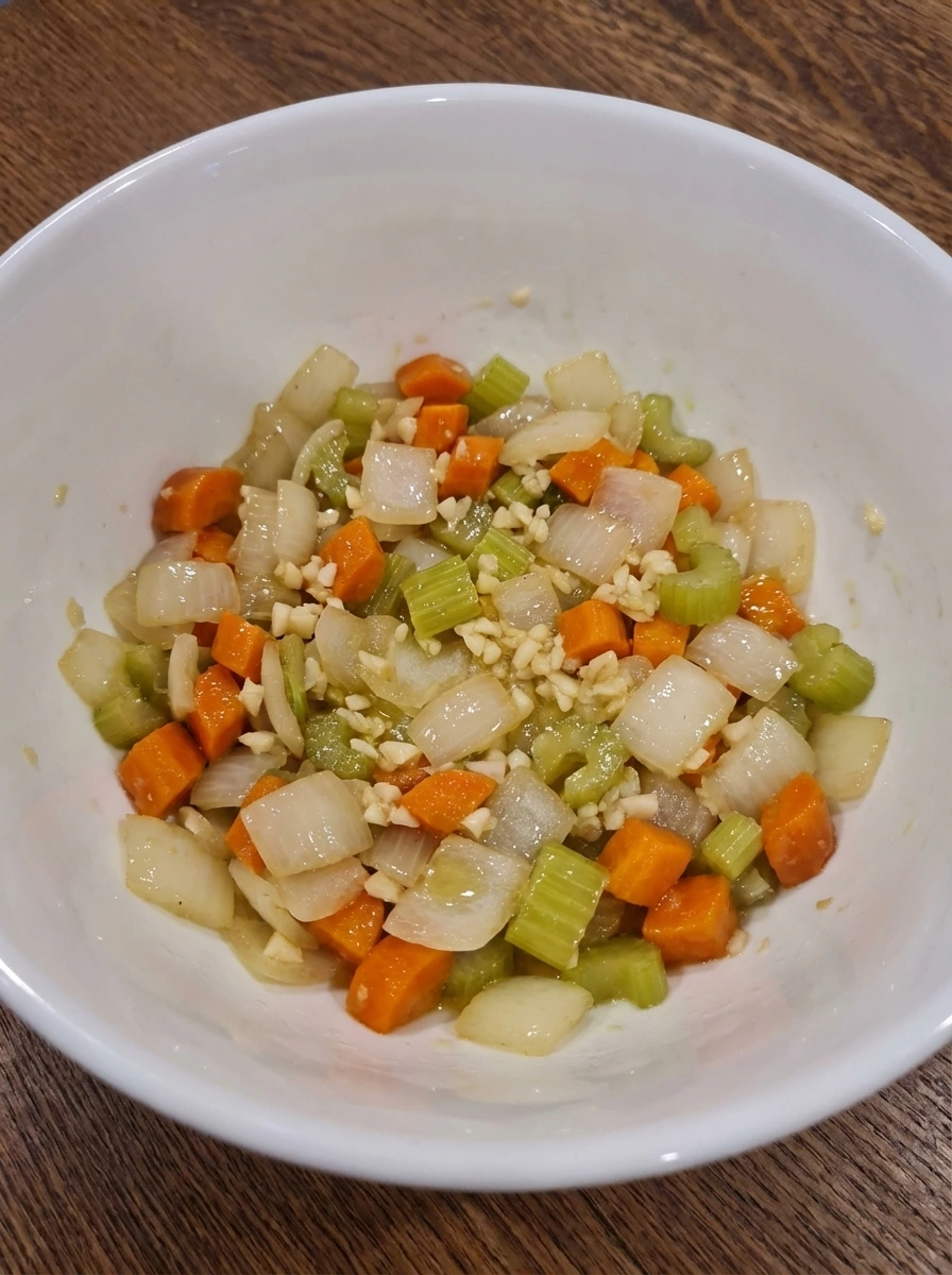 Softened vegetables mixed with minced garlic for Bolognese