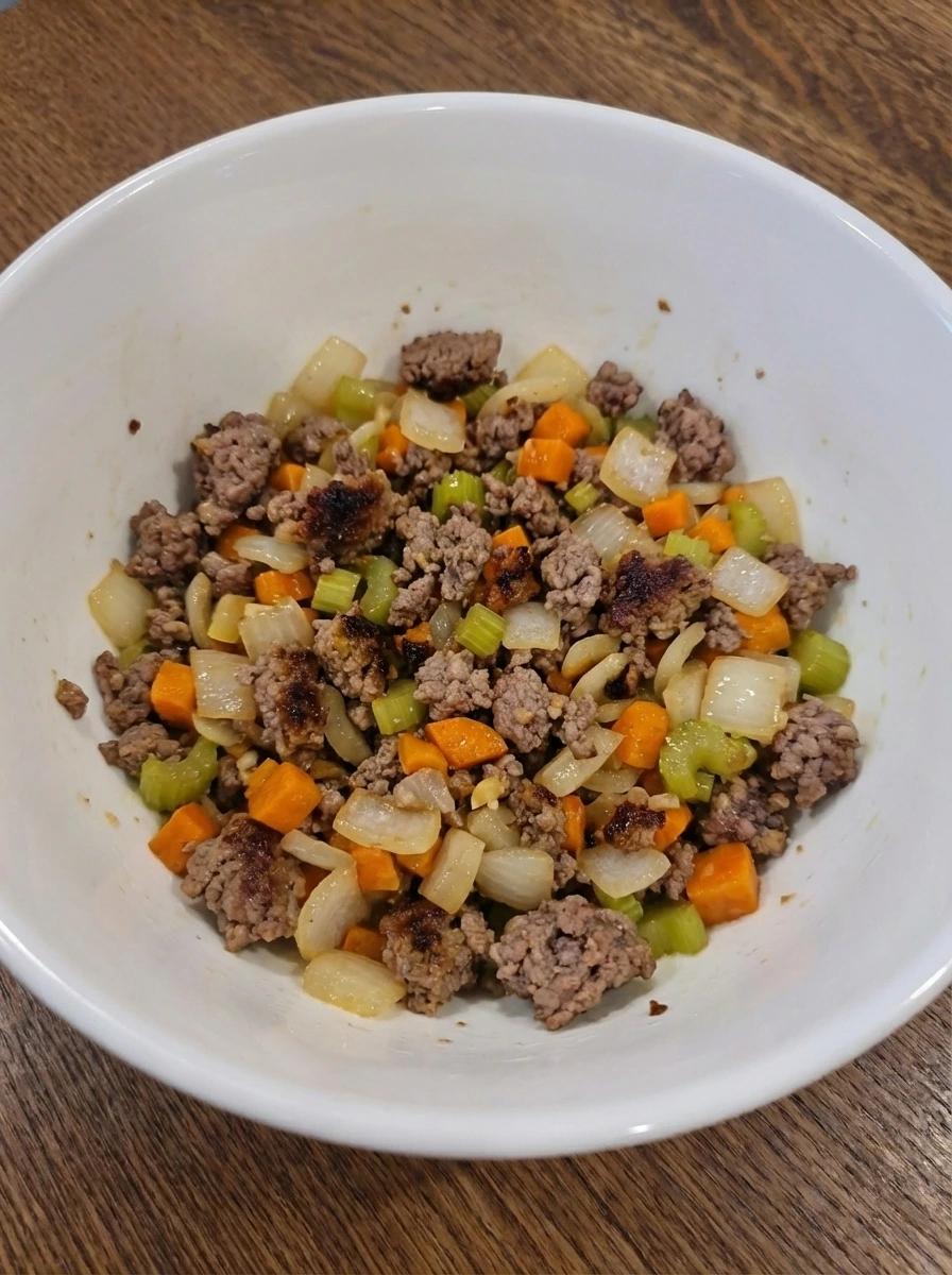 Ground beef browned with softened vegetables for Bolognese sauce