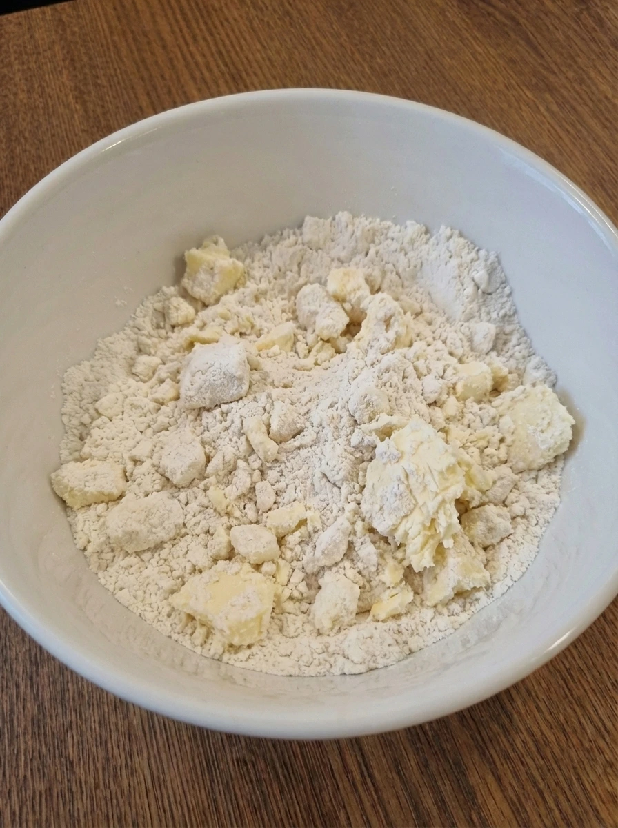 Butter coated into flour for crumbly shortcake mixture