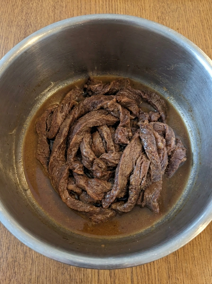 Tender cooked beef in sauce for Crock Pot Beef and Broccoli