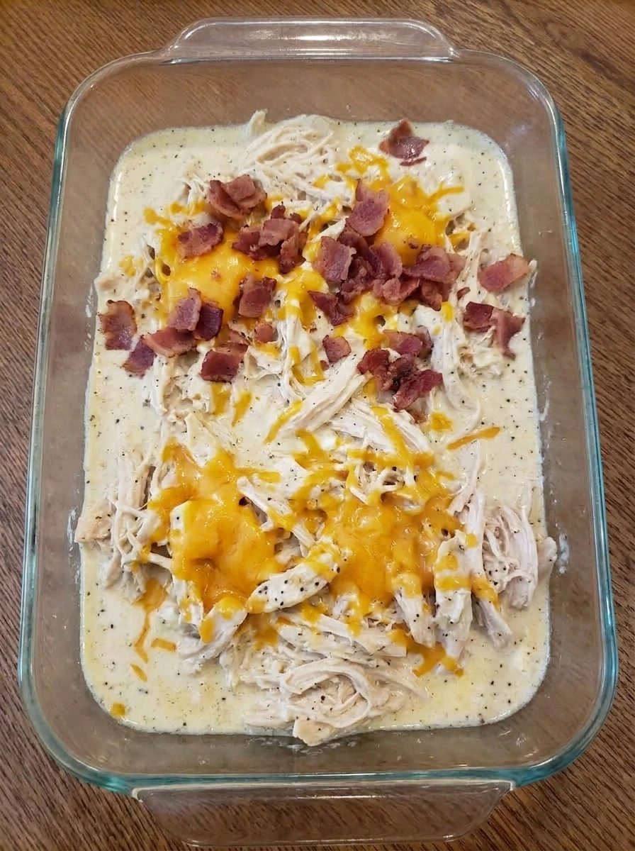 Shredded chicken mixed with cheddar and bacon in creamy sauce.