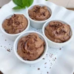 Easy Chocolate Mousse in ramekins with swirled tops and chocolate shavings.