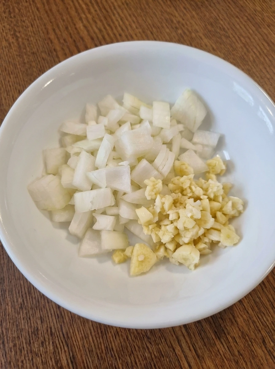 Diced onion and minced garlic prepared for Easy Ground Beef Tacos