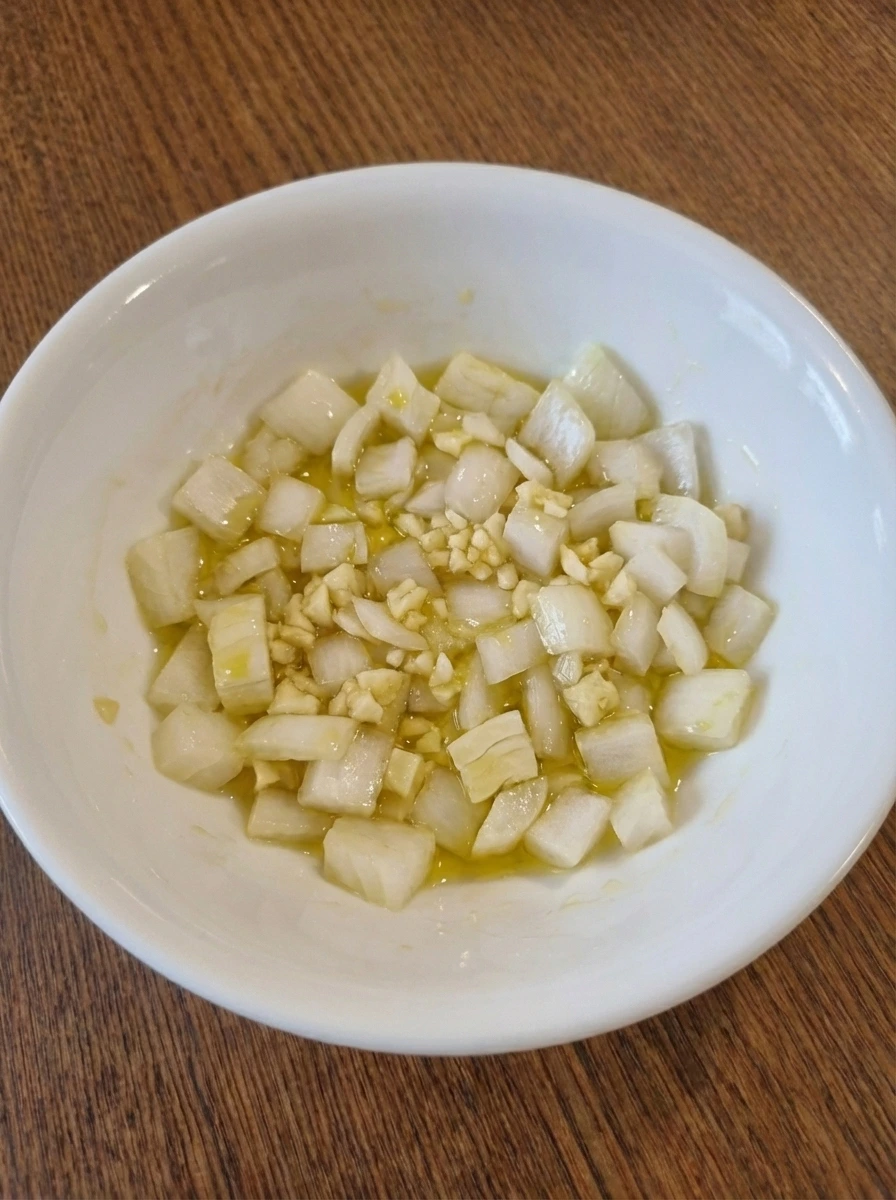 Onion and garlic lightly coated with oil for taco filling