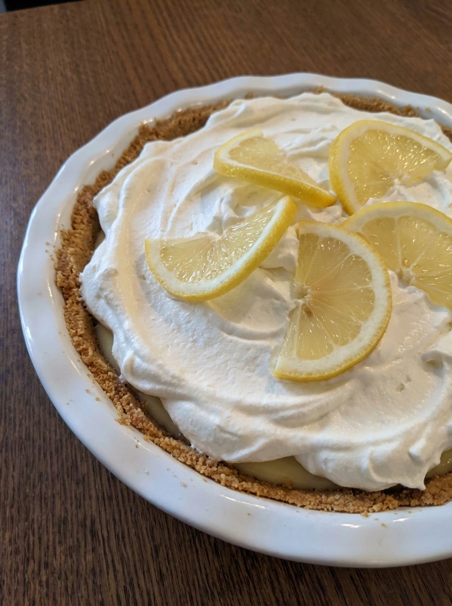 Finished Easy Lemon Cream Pie topped with whipped cream and lemon slices