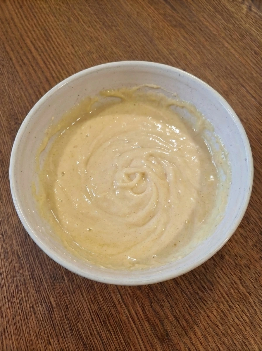 Wet ingredients blended into a smooth mixture for strawberry muffins