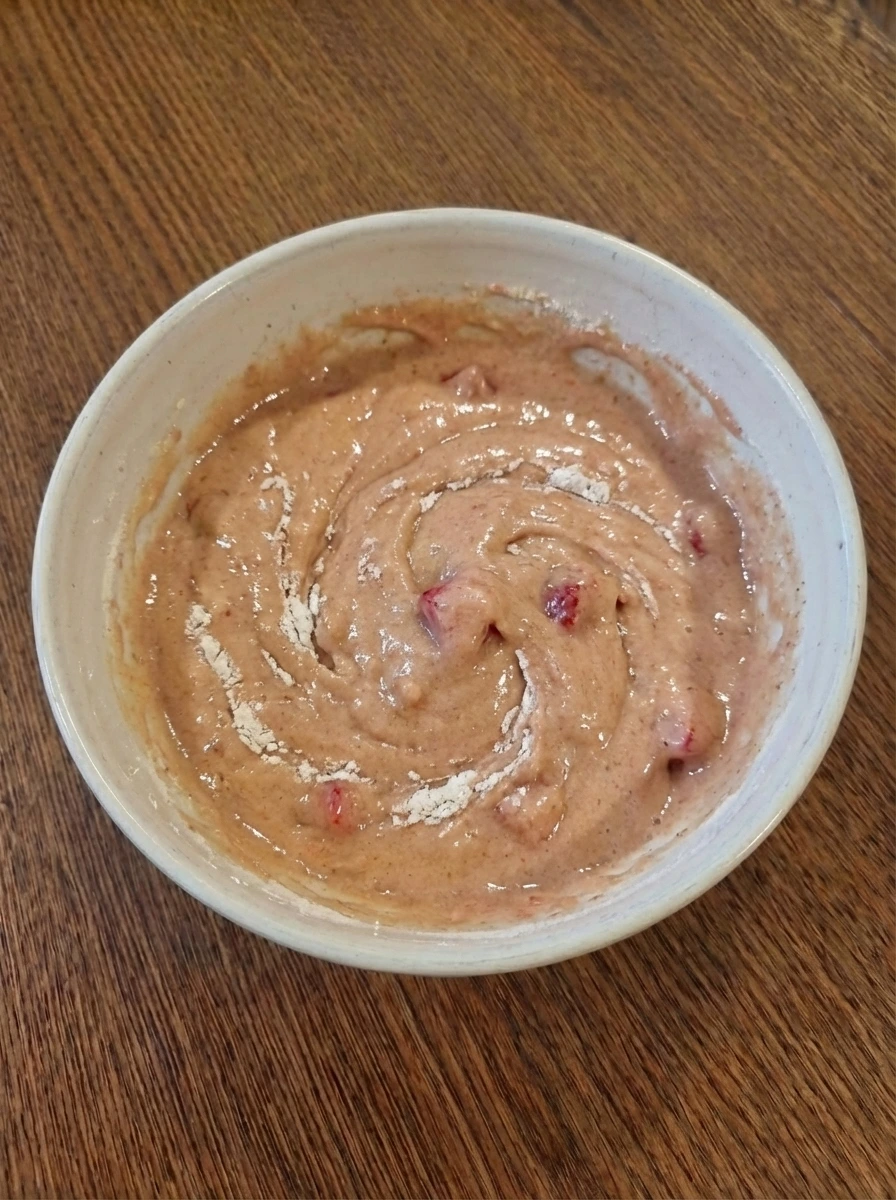 Partially mixed muffin batter in a bowl