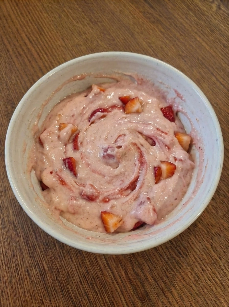 Strawberries folded into thick muffin batter