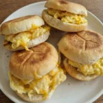 Egg and Cheese Breakfast Sandwich with melted cheddar and soft eggs on a white ceramic plate