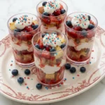 Firecracker Strawberry Shortcake Cups with strawberries, whipped cream, toasted pound cake and popping candy.