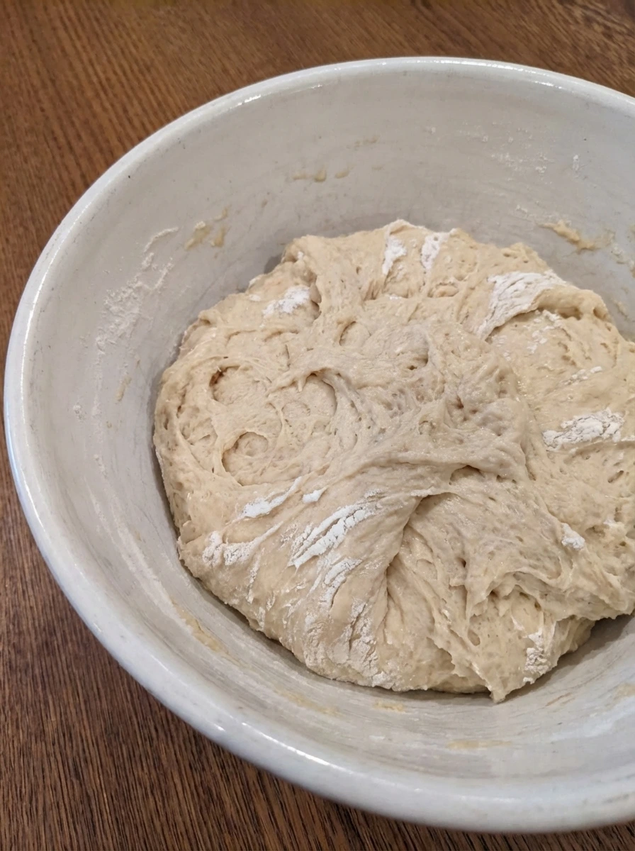 Shaggy dough for Homemade Cinnamon Rolls in a white dish