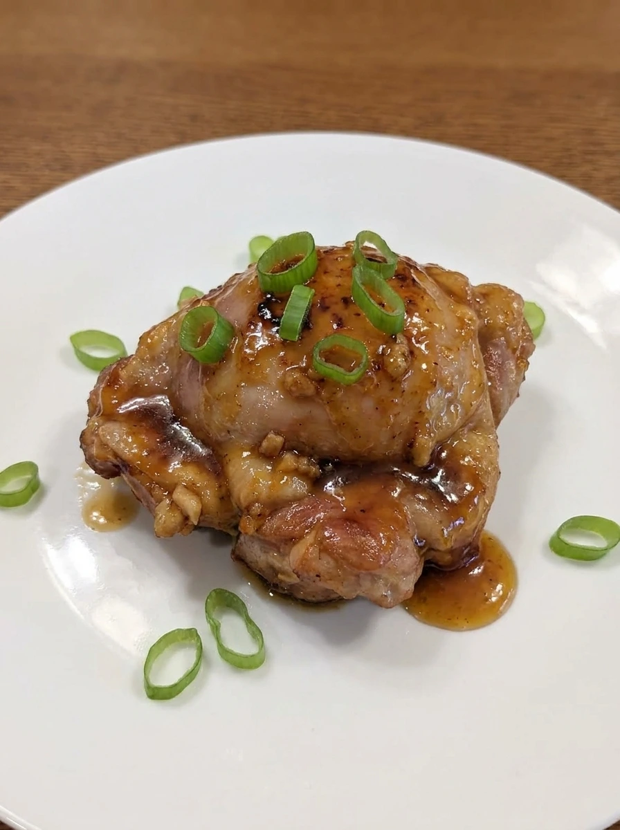 Plated Honey Garlic Chicken Thighs with green onions