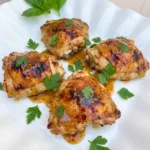 Honey Mustard Baked Chicken Thighs with glossy golden glaze and browned edges.