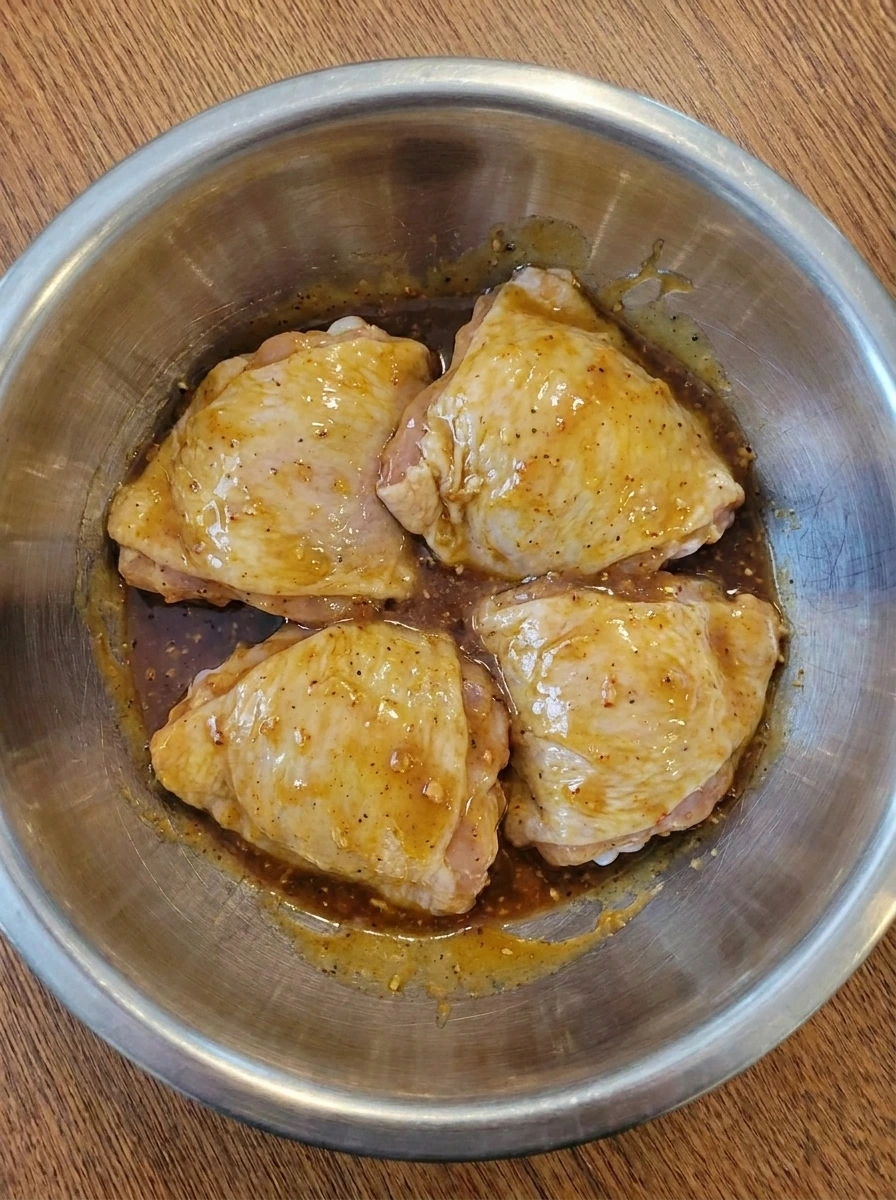 Chicken thighs coated in thick honey mustard glaze.