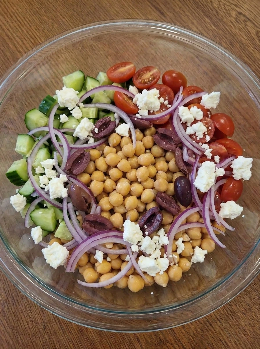 Chickpeas olives and feta added to chopped vegetables