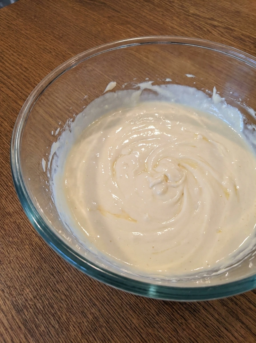 Creamy cheesecake filling mixed in a bowl