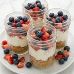 No-Bake Red White and Blue Cheesecake Jars with strawberries and blueberries
