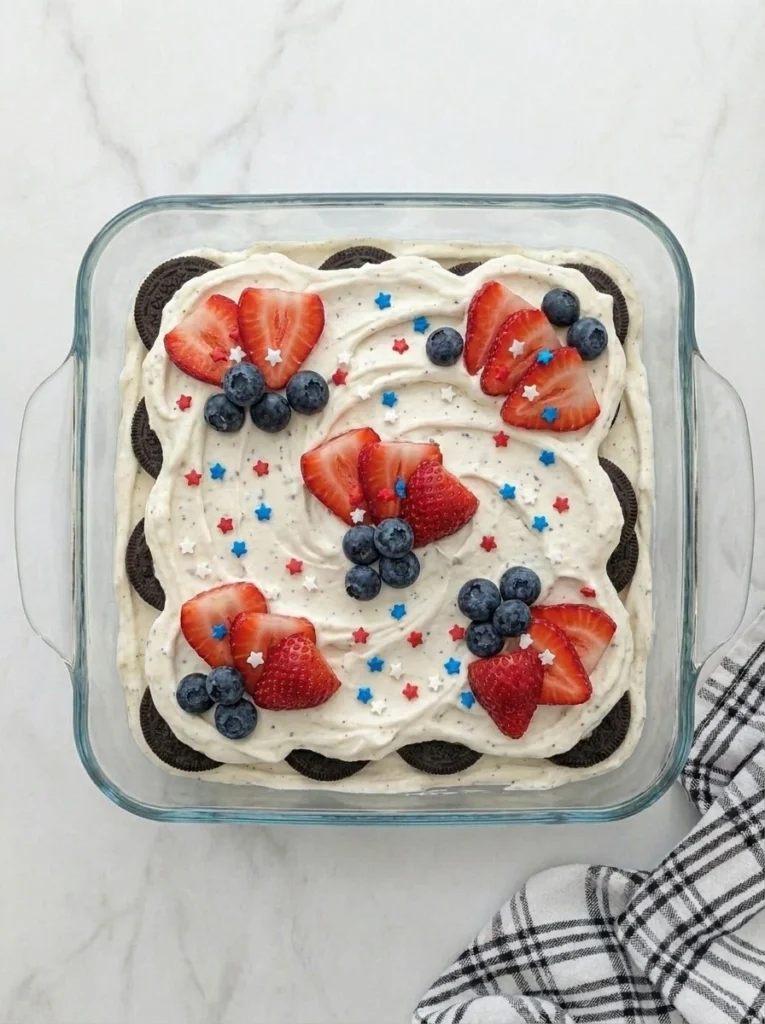Patriotic Oreo Icebox Cake with strawberries blueberries and whipped cream.