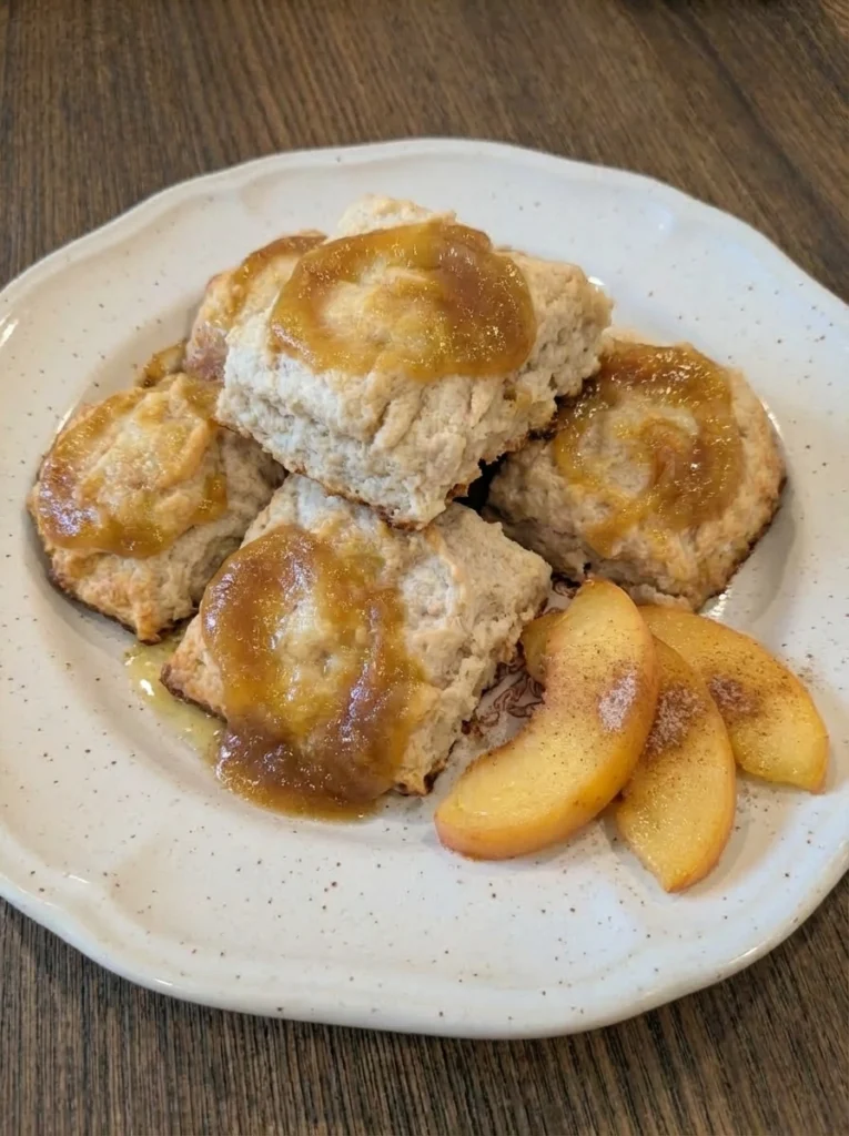 Peach Butter Swim Biscuits plated with golden edges and glossy peach swirls