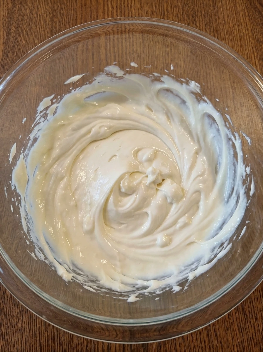 Cream cheese powdered sugar and vanilla blended into a smooth base for Pineapple Cheesecake Dip.