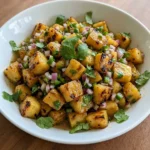 Pineapple Salsa in a white bowl with charred pineapple red onion jalapeno and cilantro.
