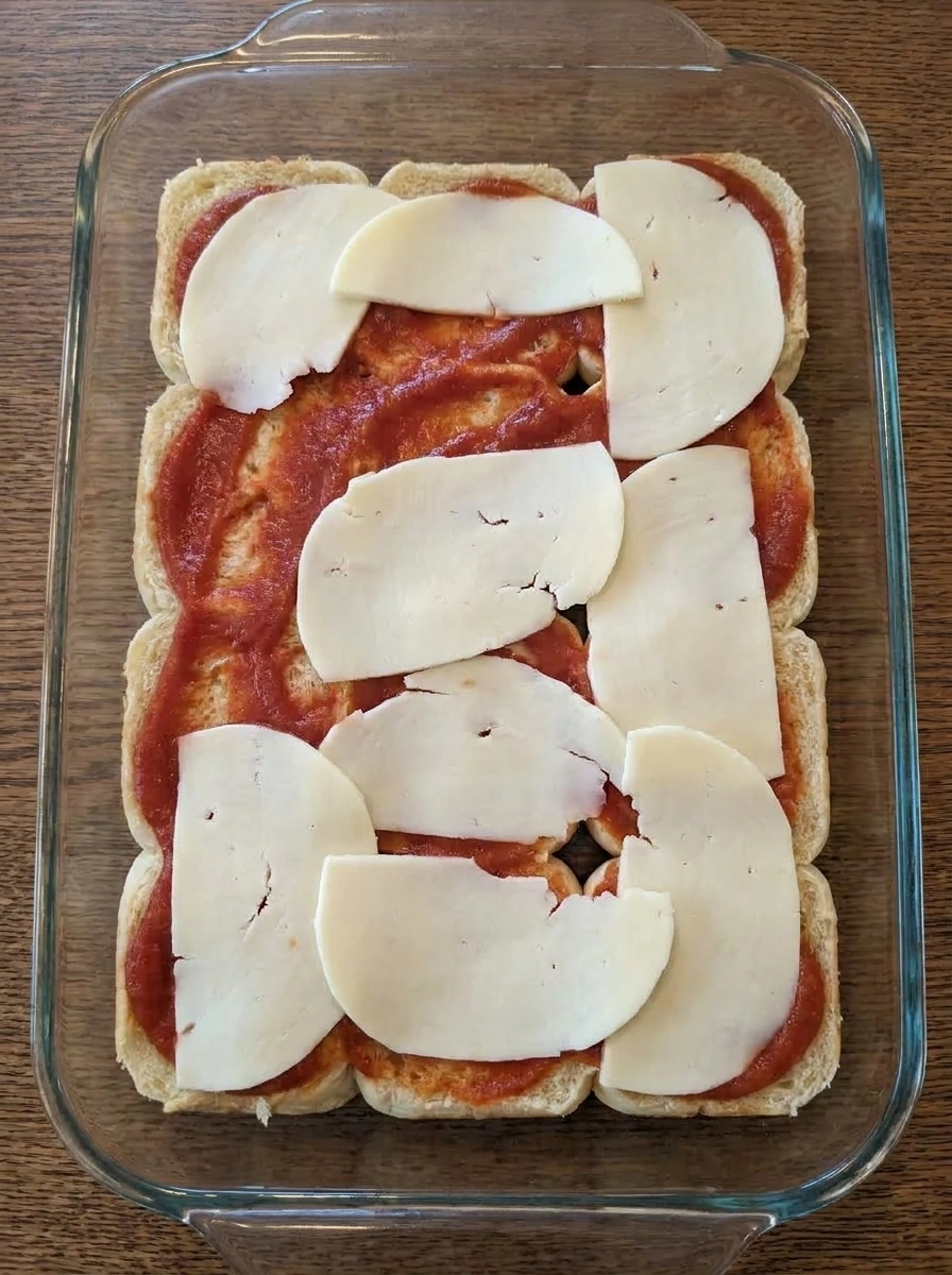 Pizza Sliders with marinara sauce and mozzarella layered on rolls