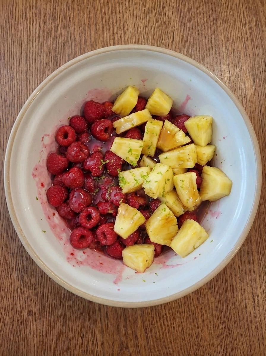 Raspberries and pineapple folded with syrup and lime into a glossy pink filling