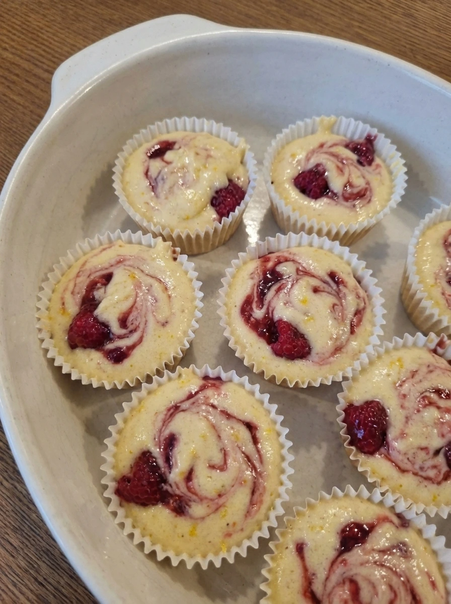 Unbaked Raspberry Lemon Heaven Cupcakes with raspberry swirls
